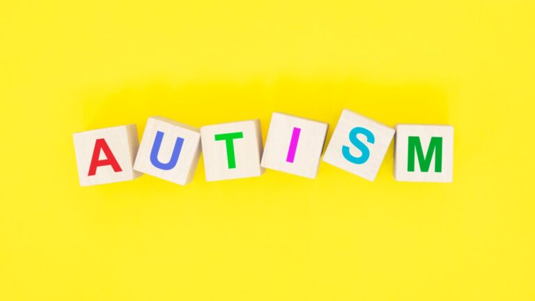 autism spelt out in blocks on a yellow background
